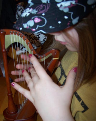 Emily borrows Buddy Jim's harp for the occasion...