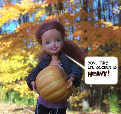 Isobel wrassles a Hallowe'en pumpkin...