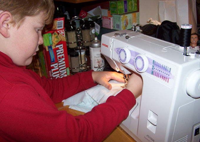 (My goodness!  He sews QUICKLY!)